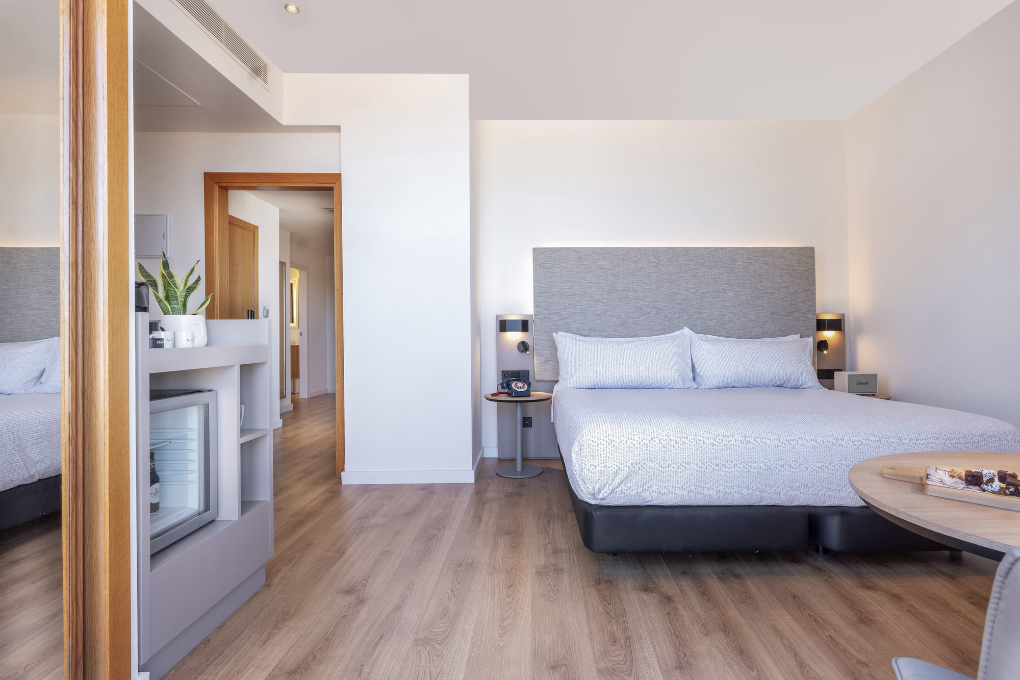 a bedroom with a bed and a wood floor