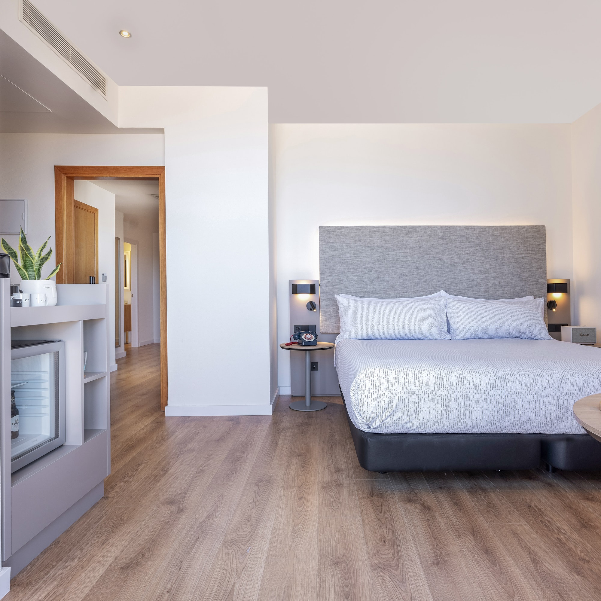 a bedroom with a bed and a wood floor