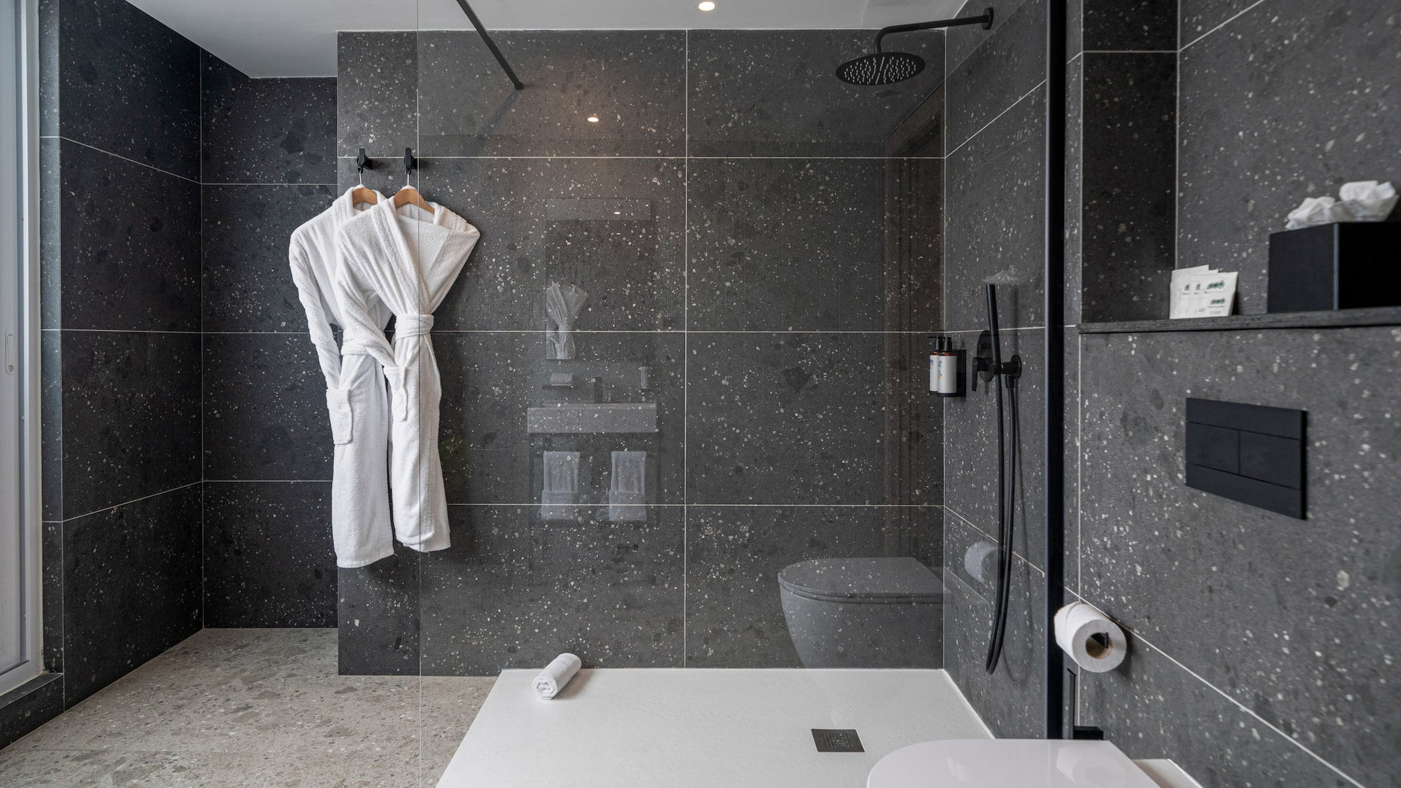 a bathroom with a shower and a bathrobe