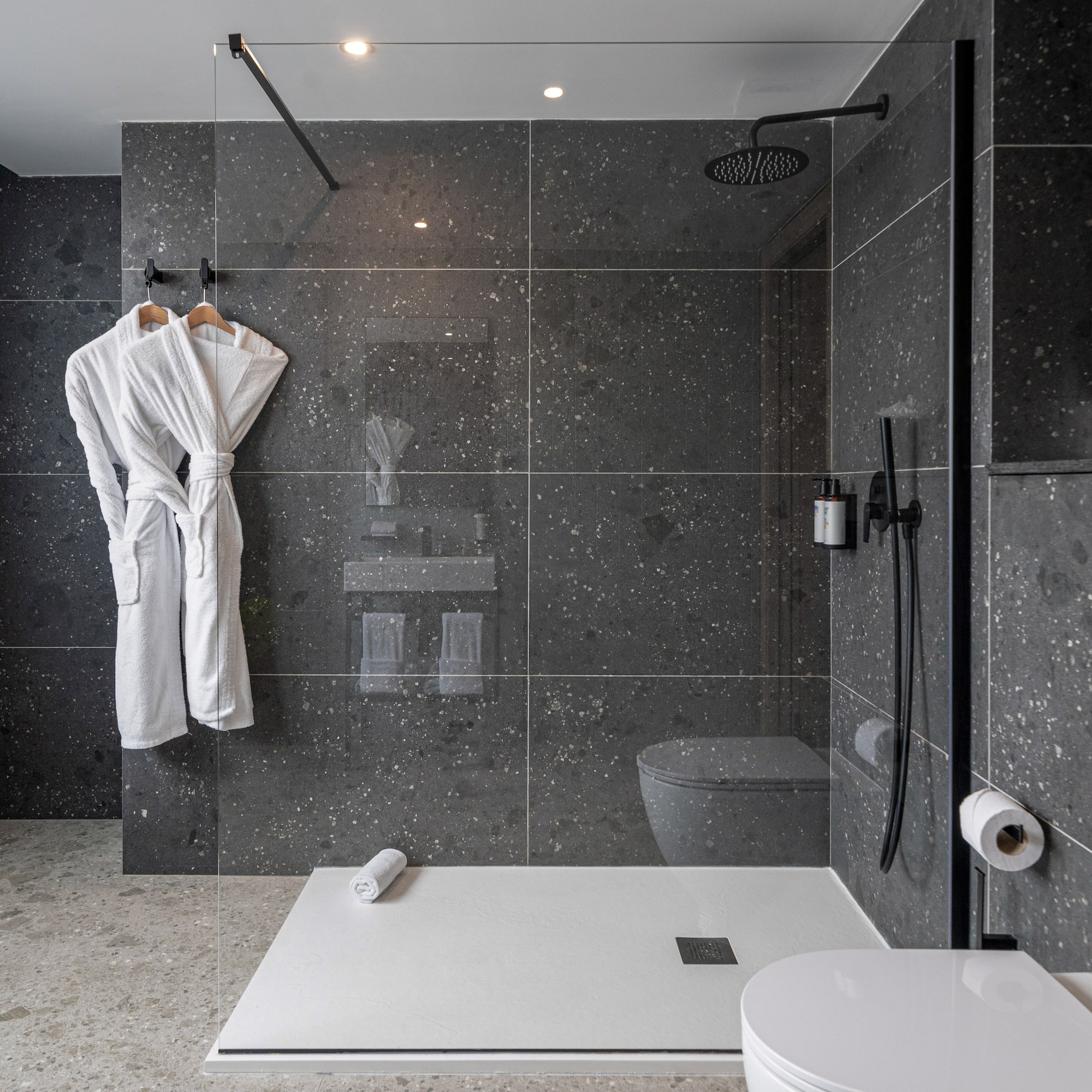 a bathroom with a shower and a bathrobe