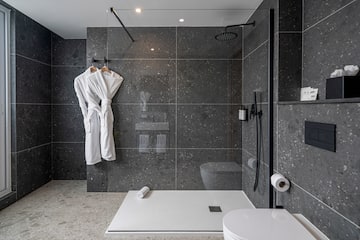 a bathroom with a shower and a bathrobe