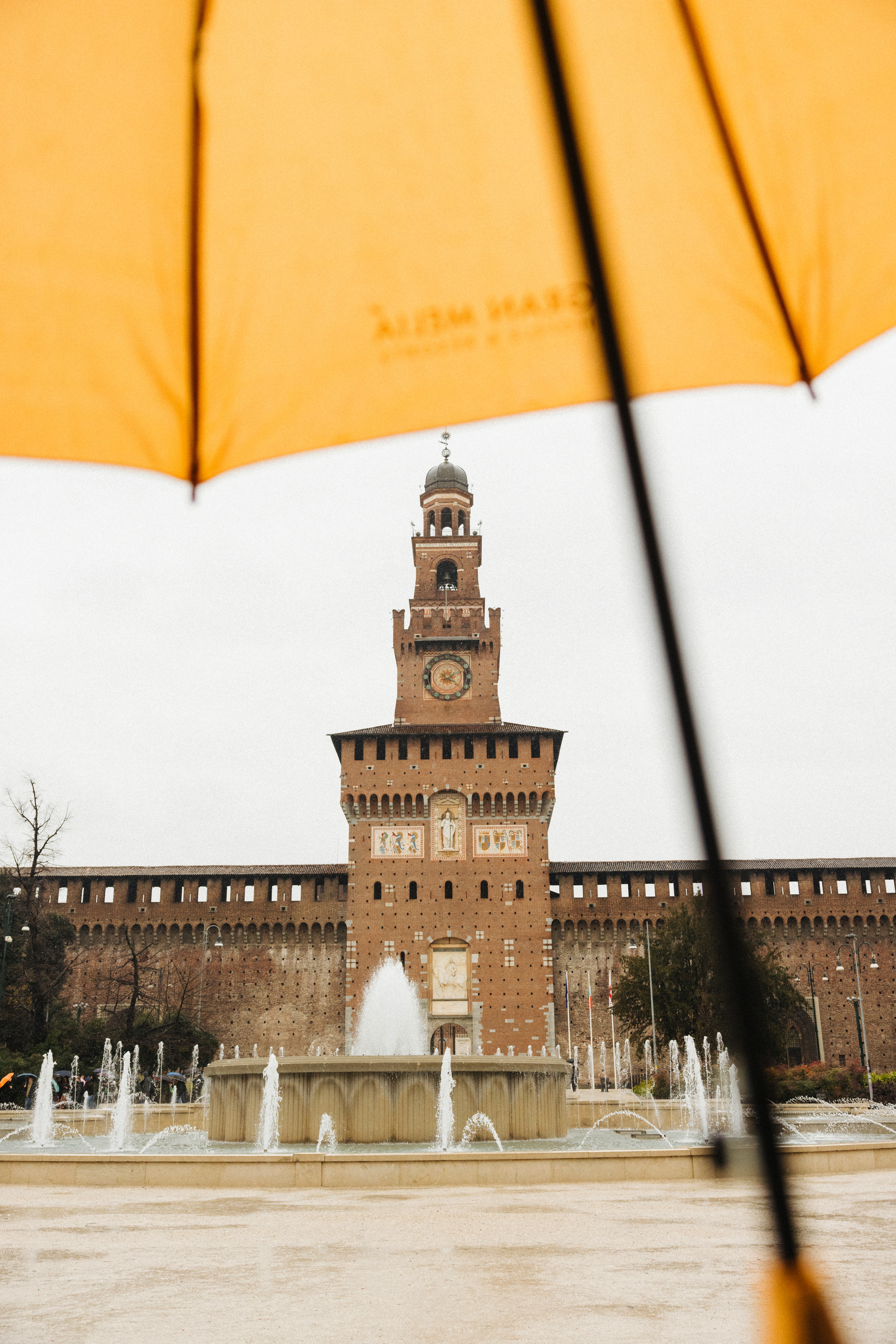 a large building with a clock tower and a fountain