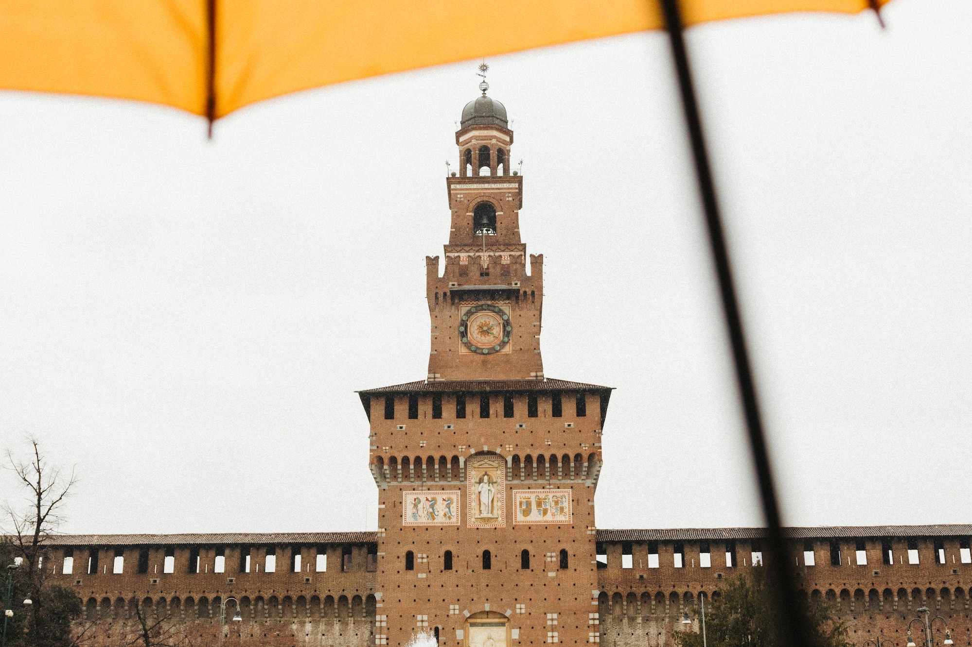 a large building with a clock tower and a fountain