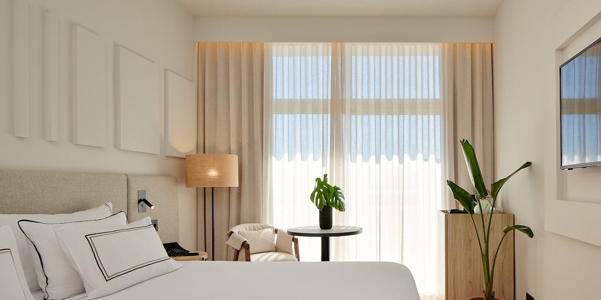 a room with a bed and a plant