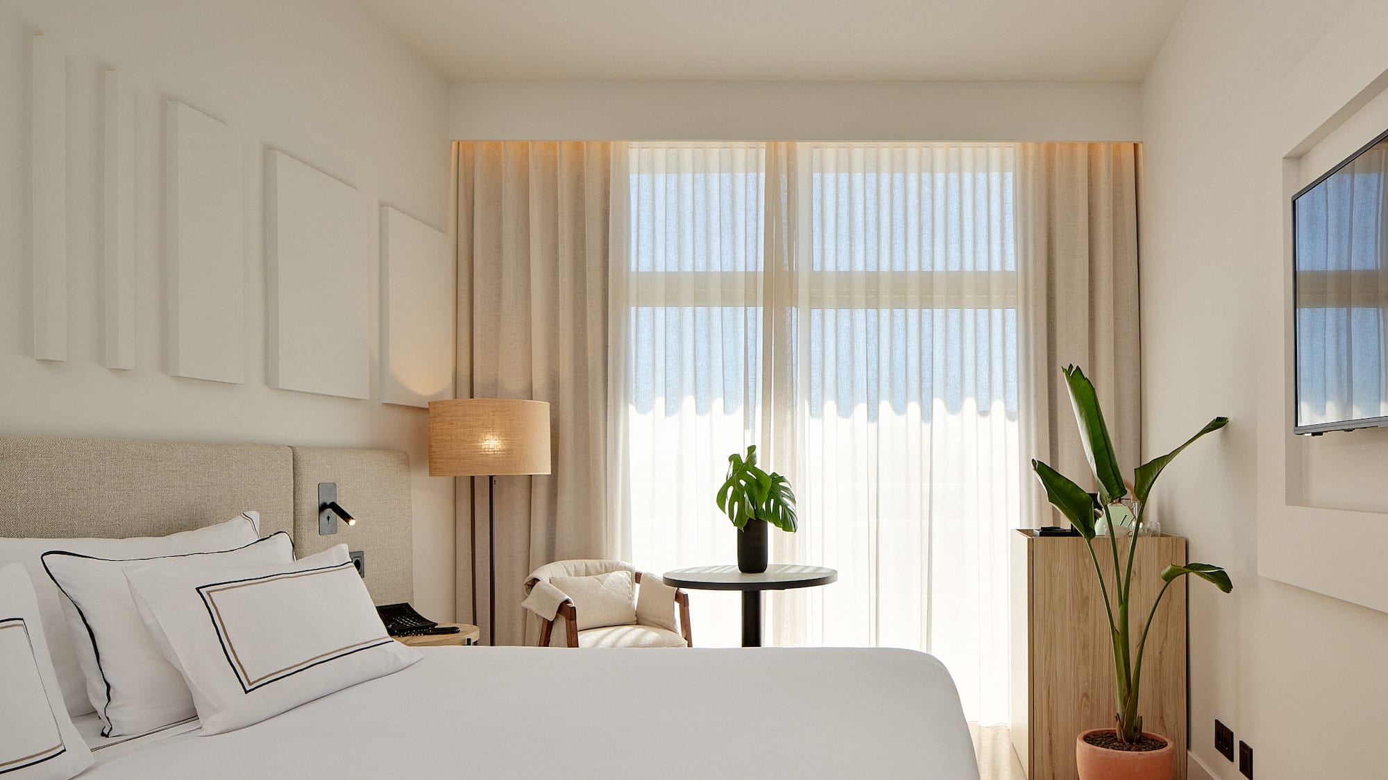 a room with a bed and a plant