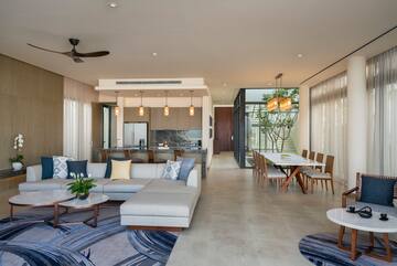 a living room with a couch and dining table