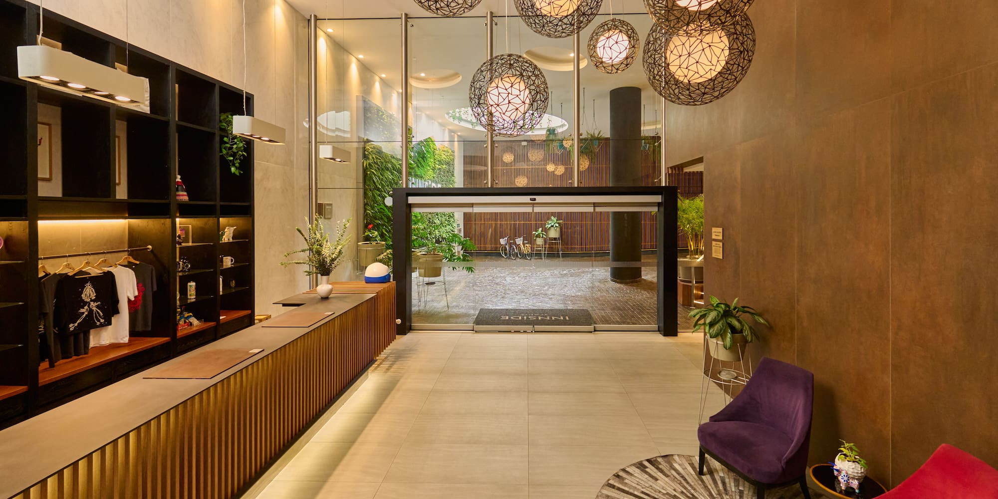 a lobby with a glass wall and a reception desk