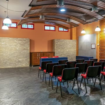 a room with chairs and a stone wall