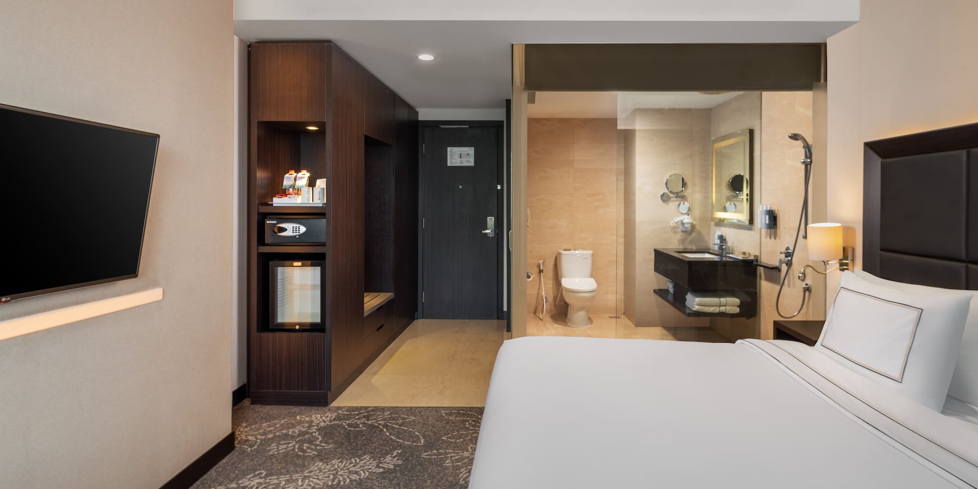 a hotel room with a bed and a toilet