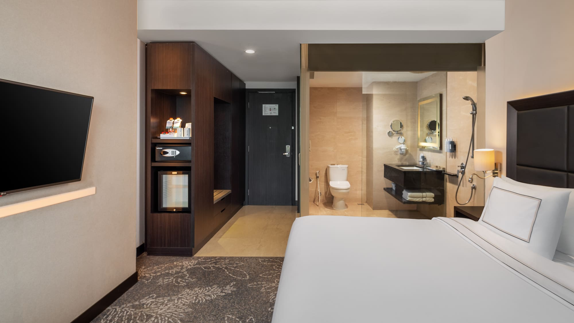 a hotel room with a bed and a toilet