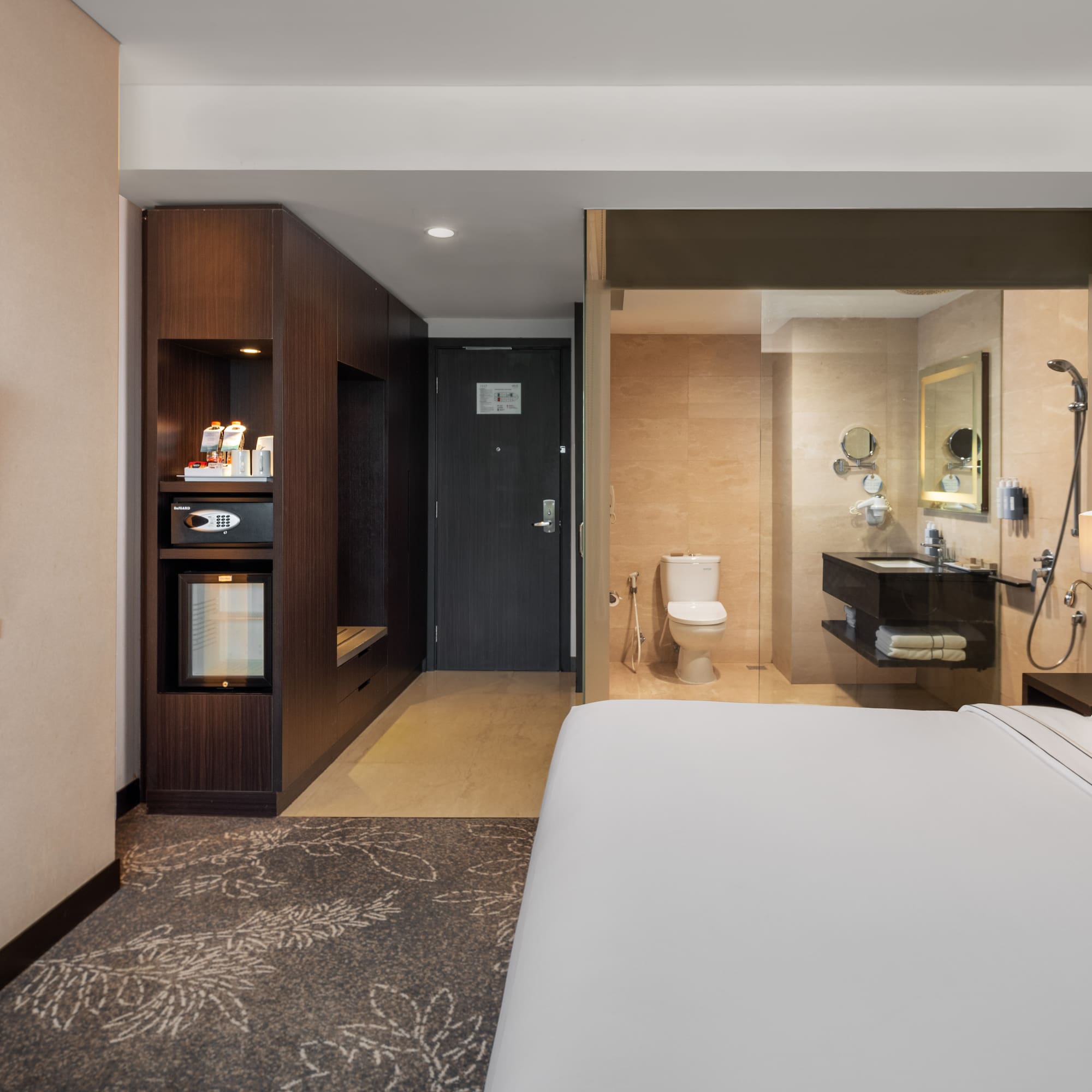 a hotel room with a bed and a toilet