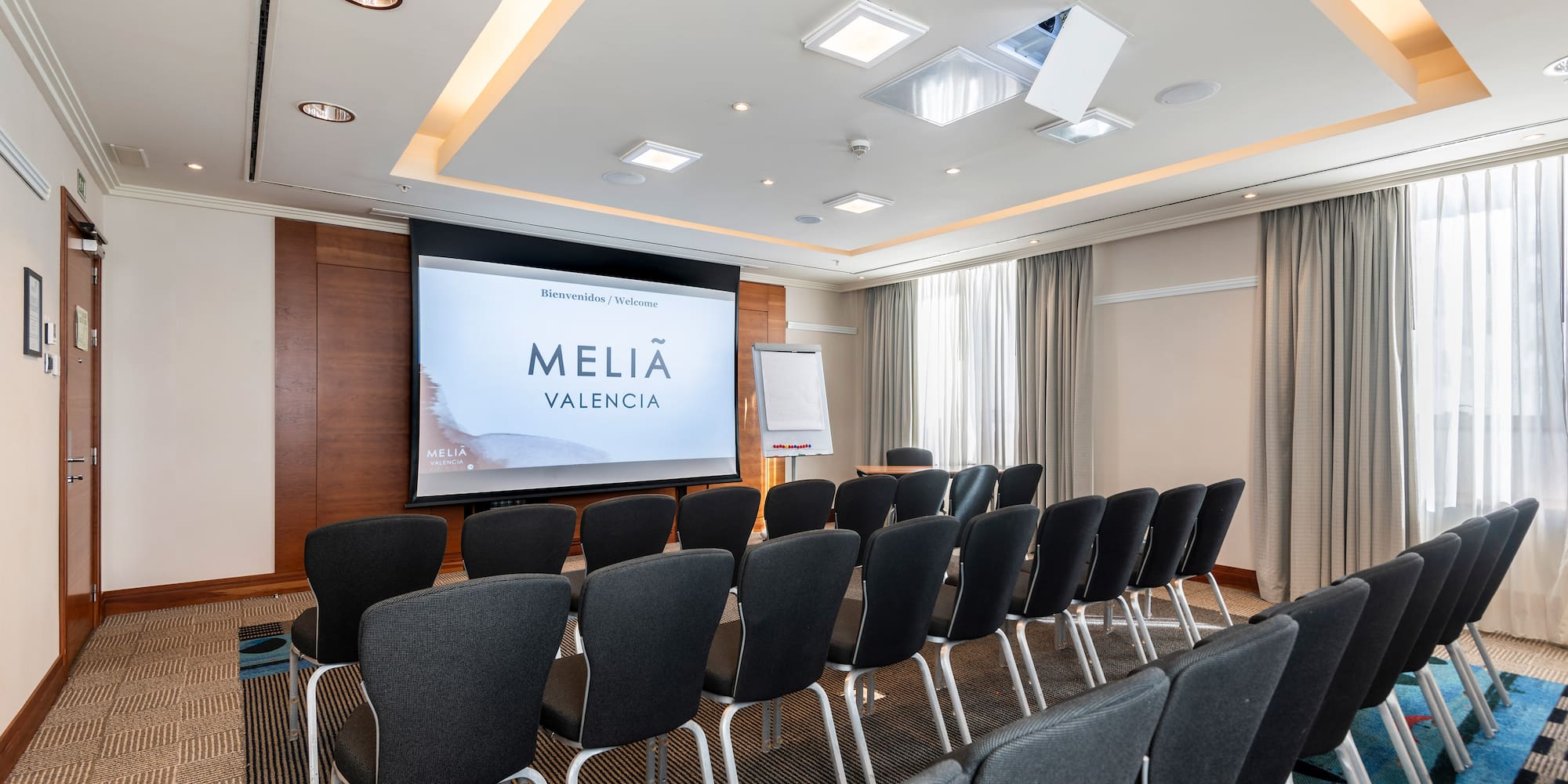 a room with chairs and a projector screen