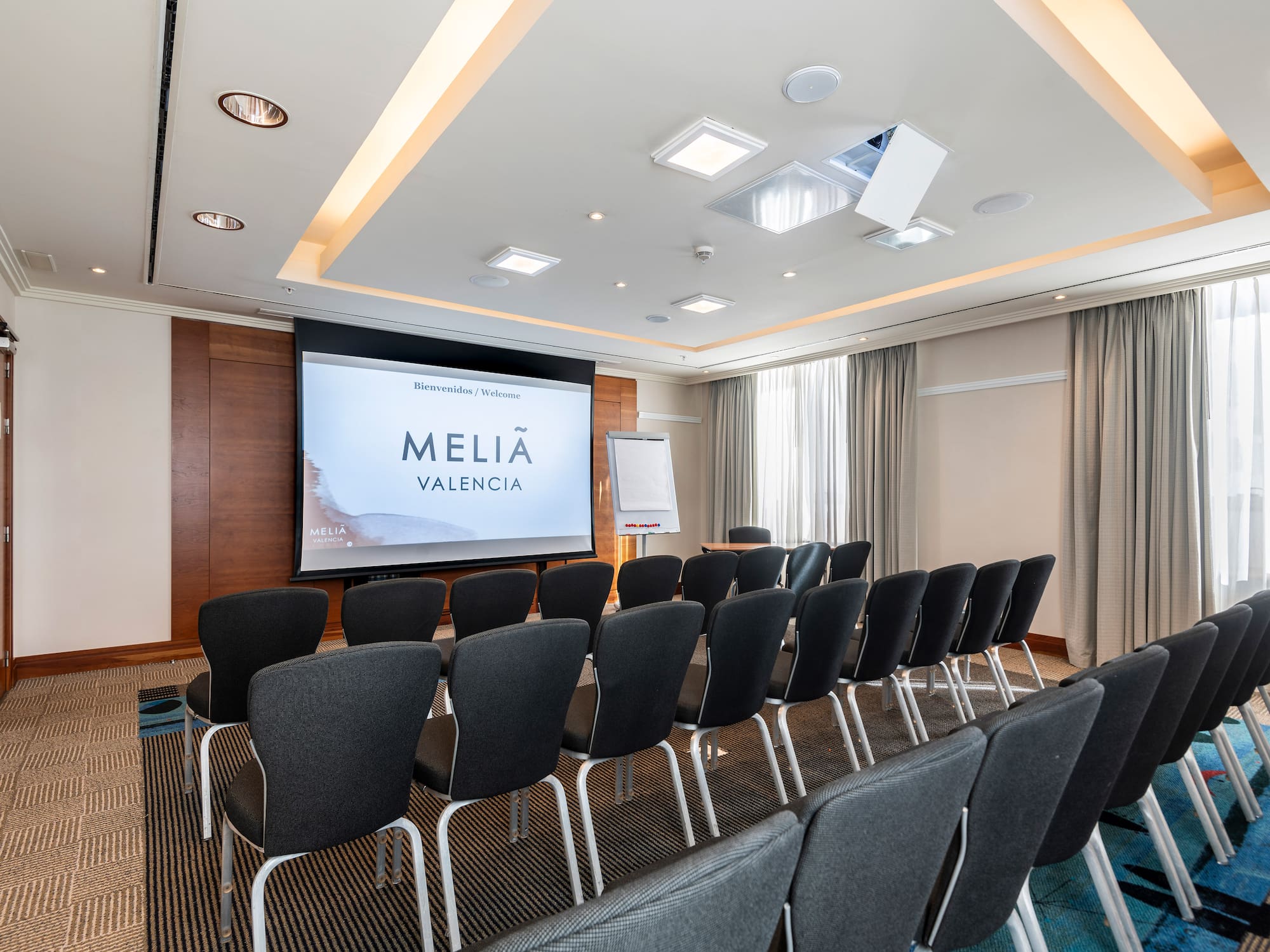 a room with chairs and a projector screen