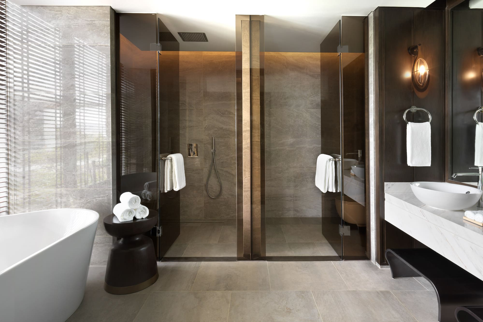 a bathroom with glass doors and a tub