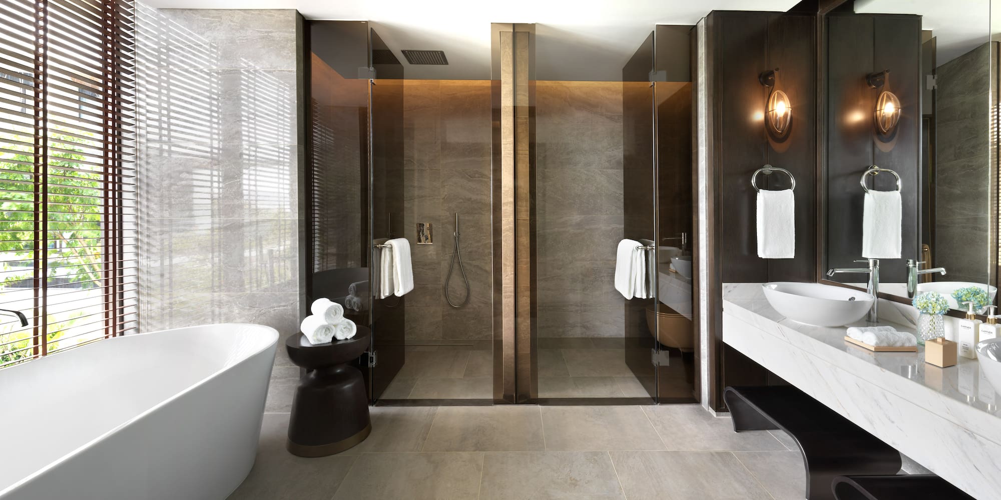 a bathroom with glass doors and a tub