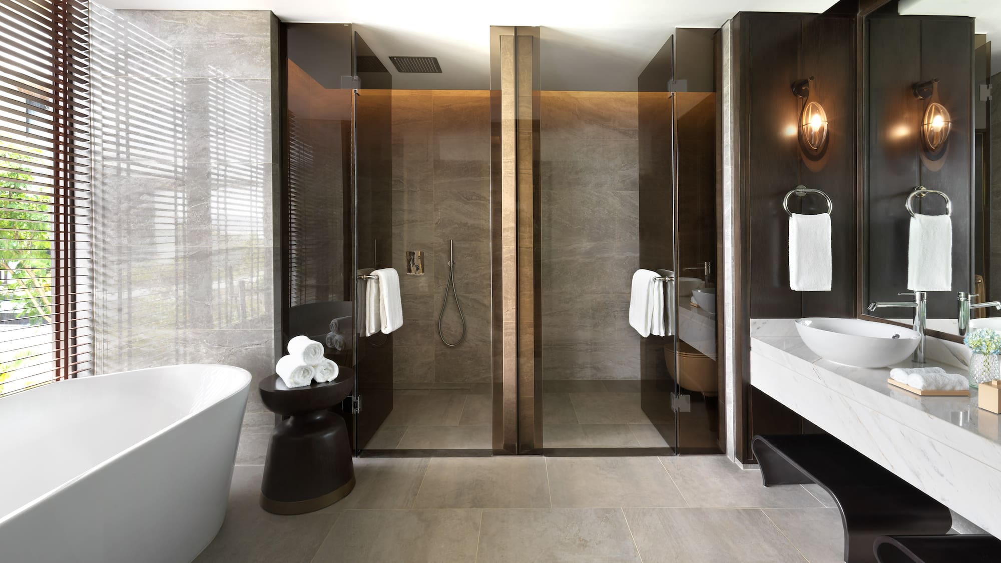 a bathroom with glass doors and a tub