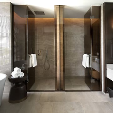 a bathroom with glass doors and a tub
