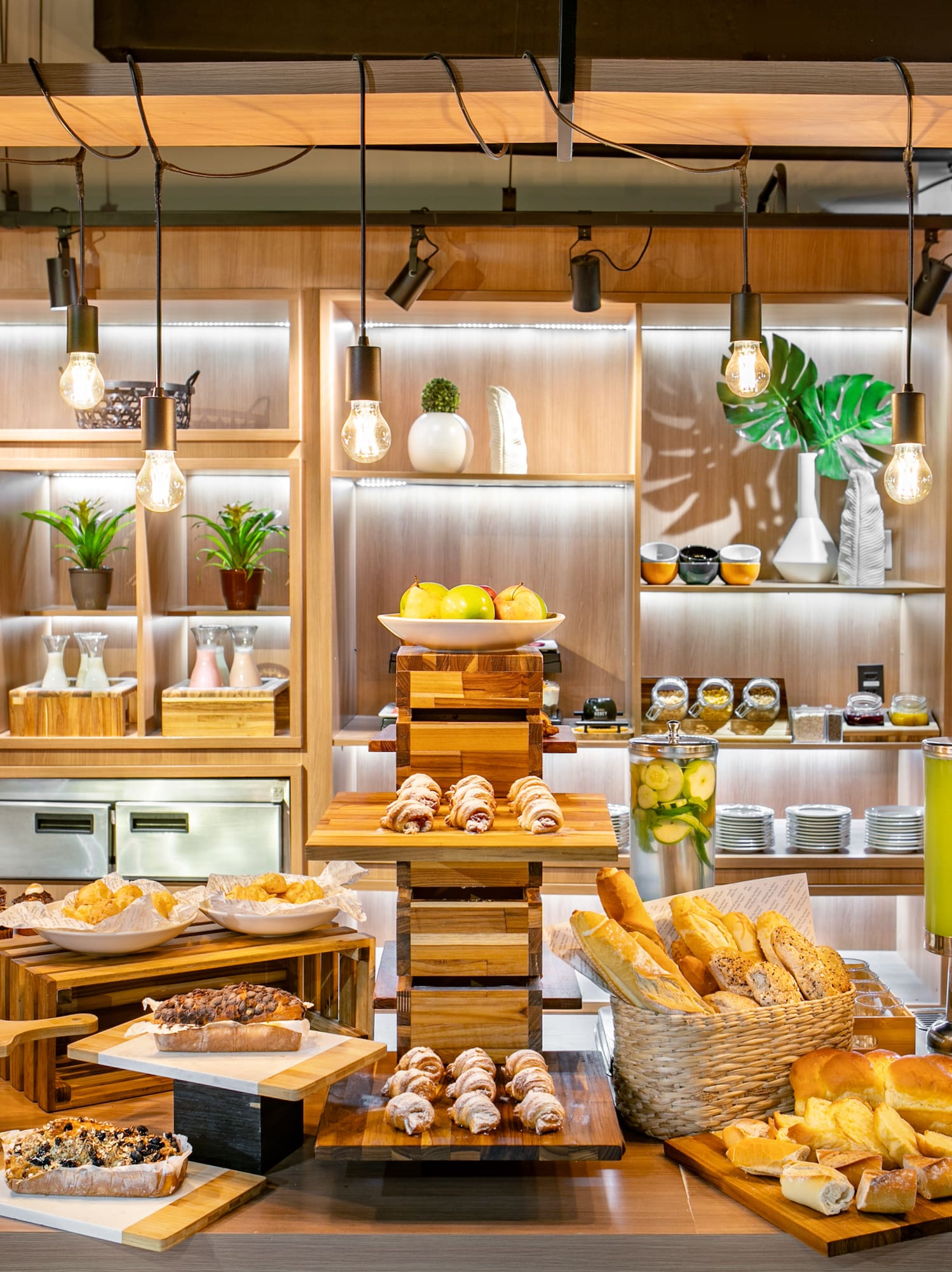 Hotel breakfast buffet with pastries, breads, fresh fruit, and juices.