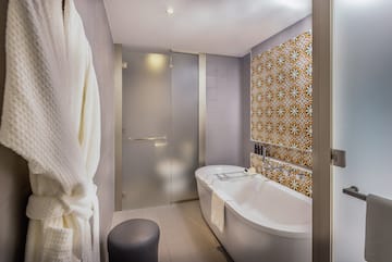 a bathroom with a tub and a shower