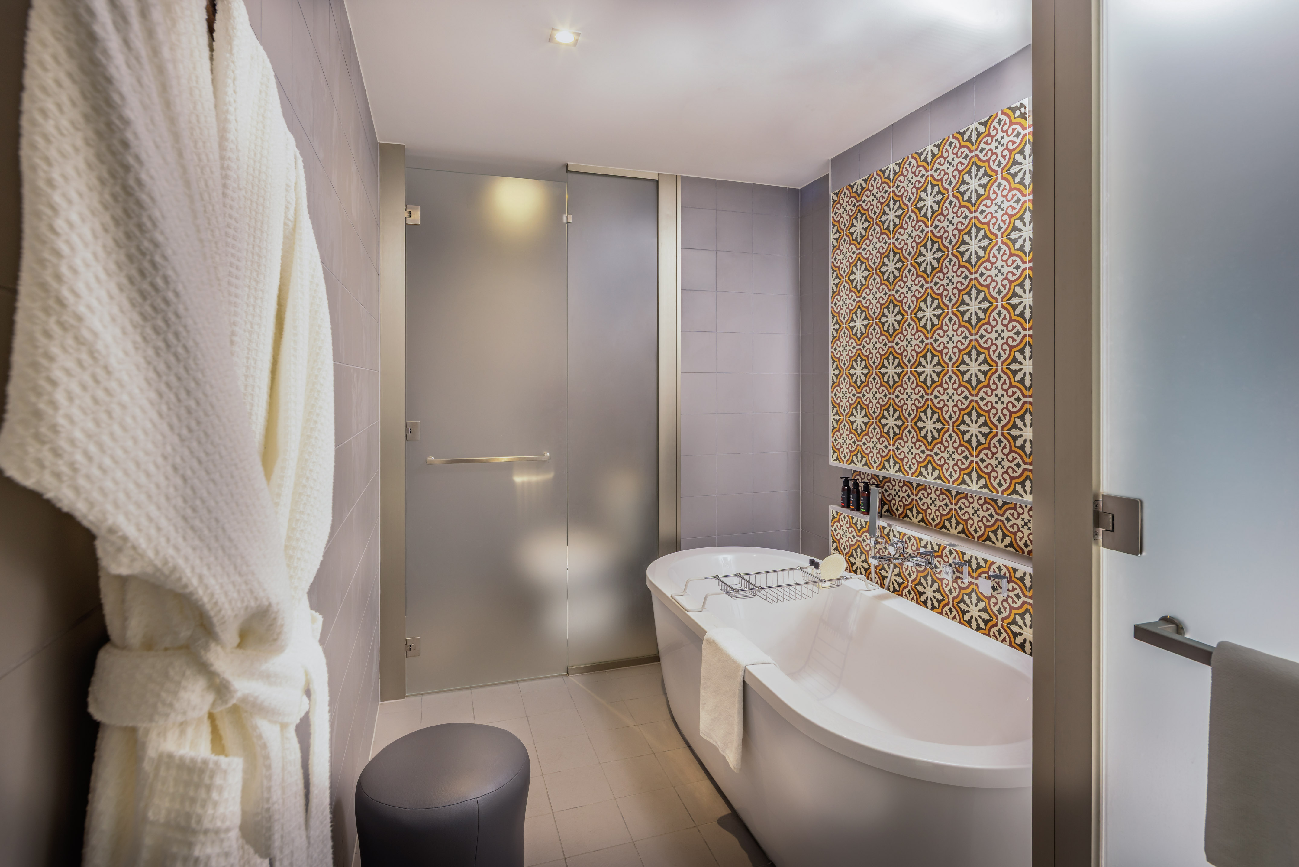 a bathroom with a tub and a shower