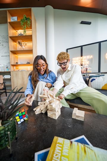 a man and woman playing with blocks