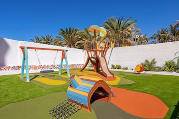 a playground with a swing and a slide
