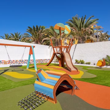 a playground with a swing and a slide