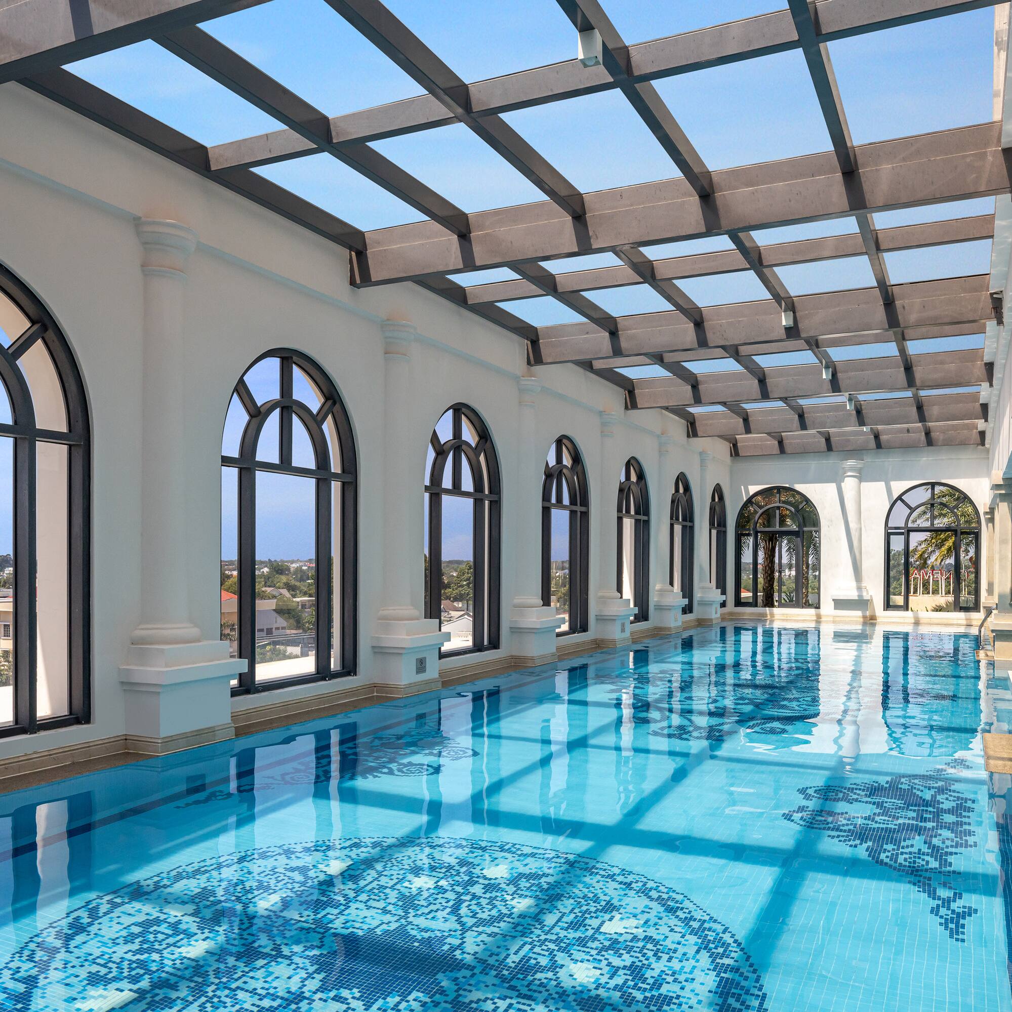 a indoor pool with arched windows