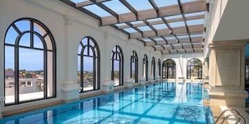 a indoor pool with arched windows