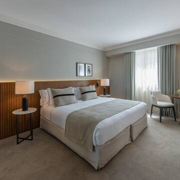 a bedroom with a bed and a table and chairs