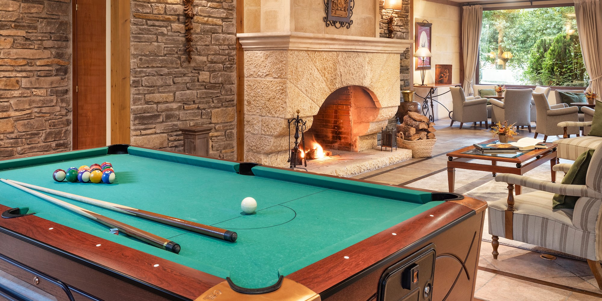 a pool table in a room with a fireplace