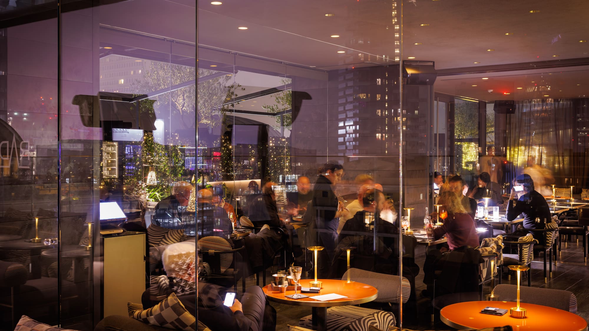 a group of people sitting at tables in a restaurant