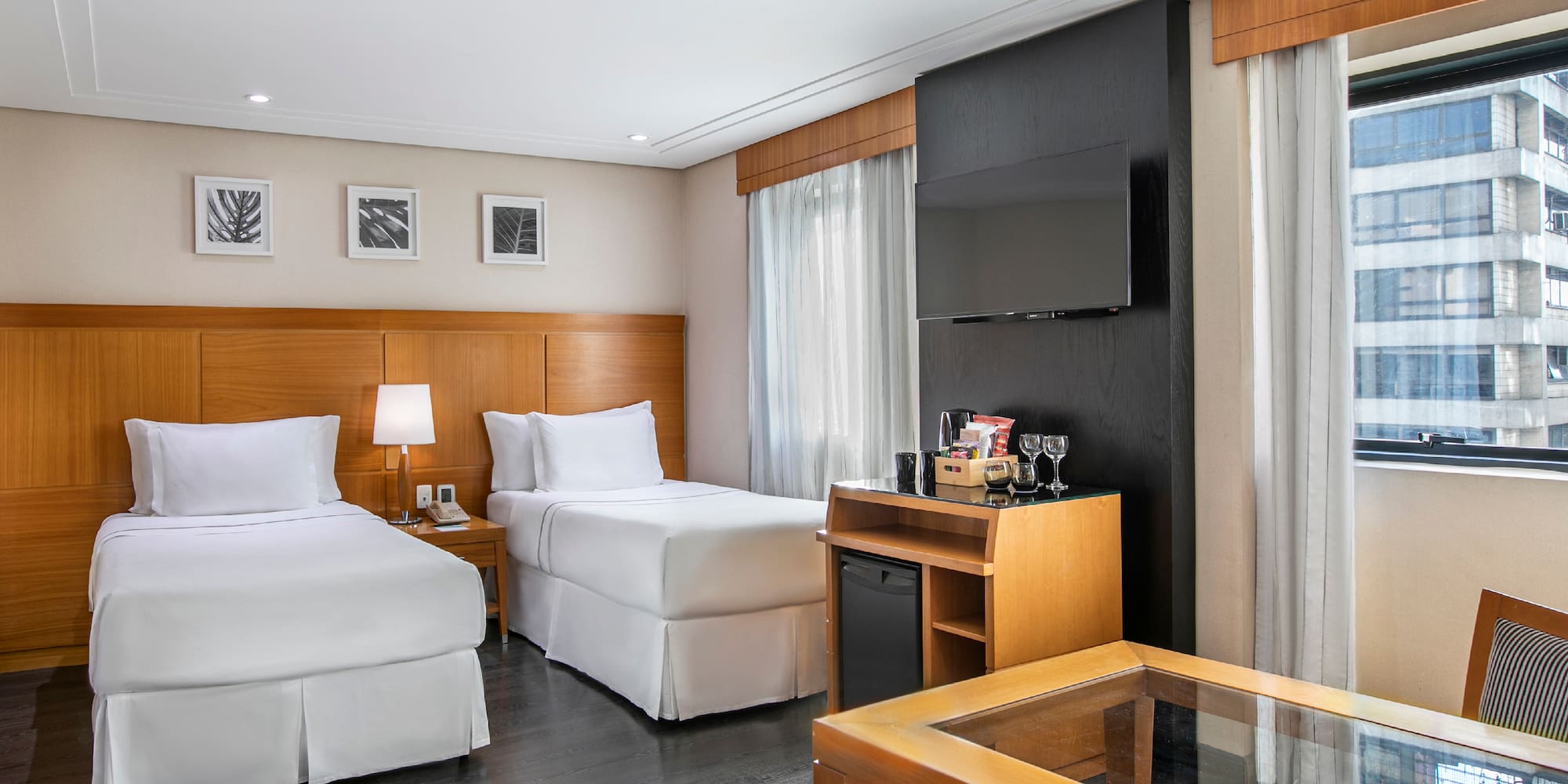 a room with two beds and a tv