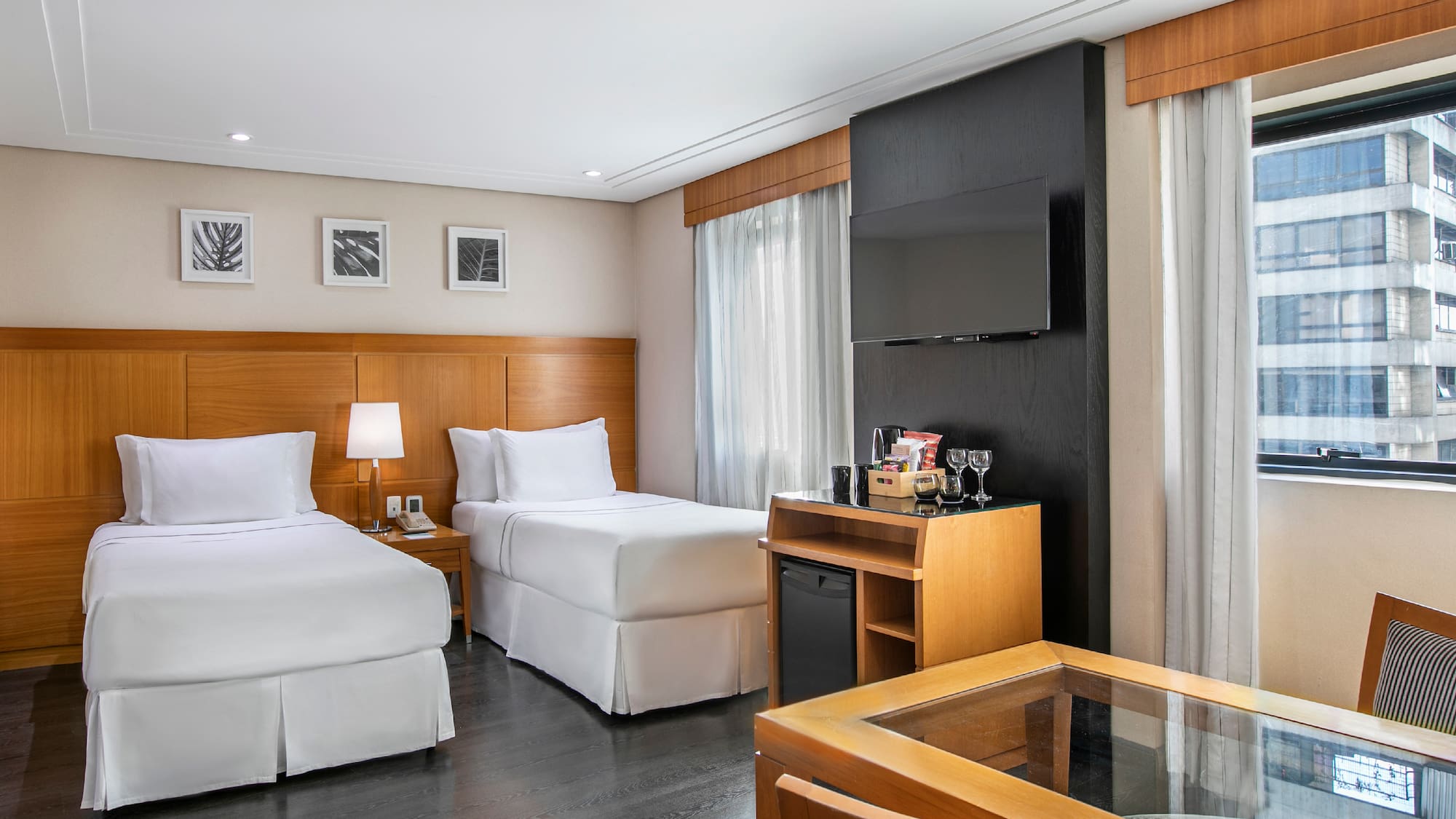 a room with two beds and a tv