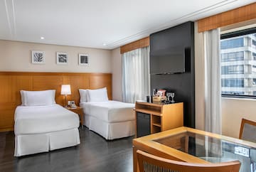 a room with two beds and a tv