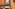Terracotta balcony with wicker chairs, table, sunglasses, and palm trees.