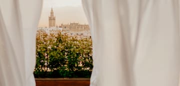 a window with a city skyline in the background