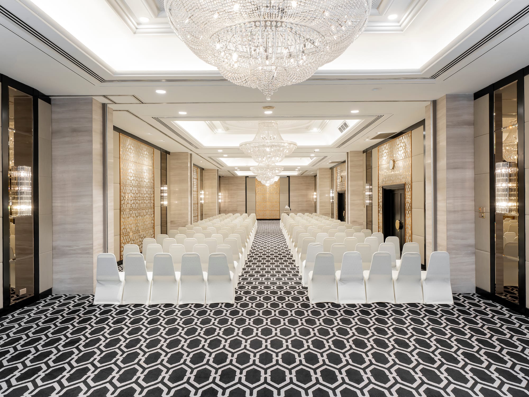 a room with chairs and chandeliers