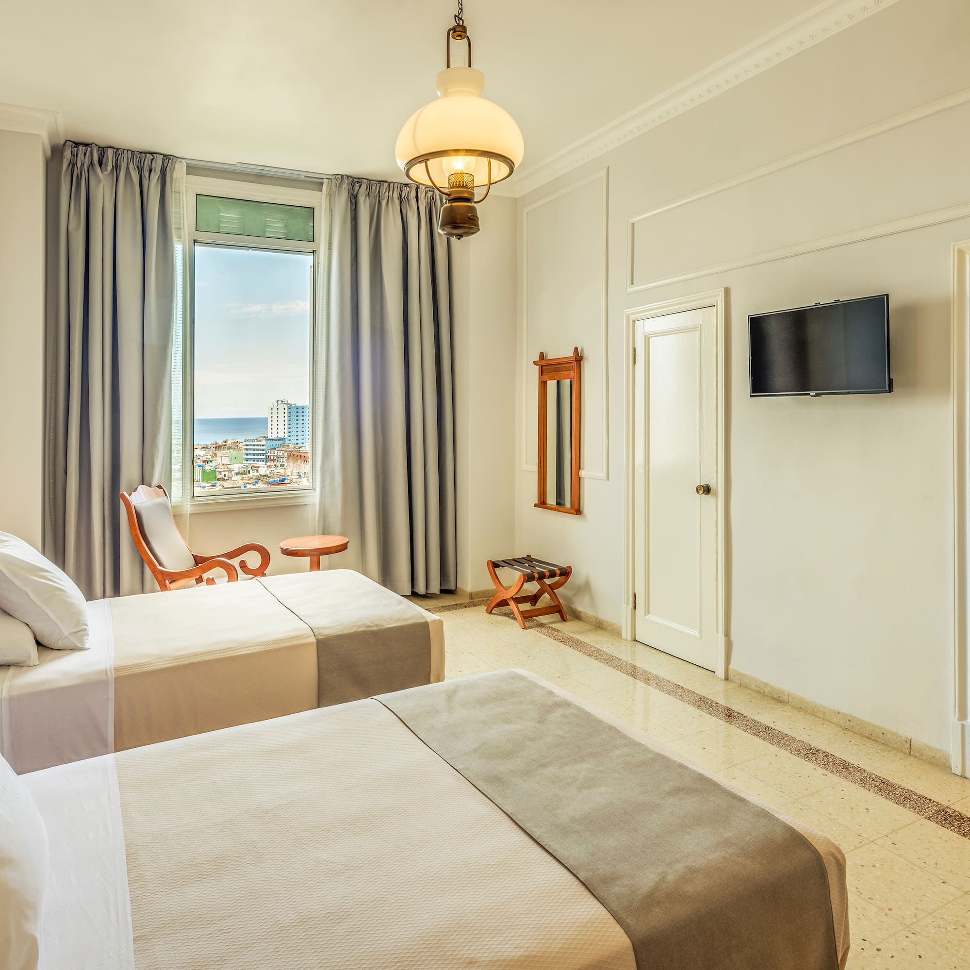 a room with two beds and a television