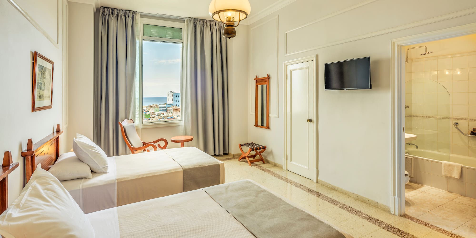 a room with two beds and a television