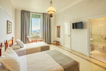 a room with two beds and a television