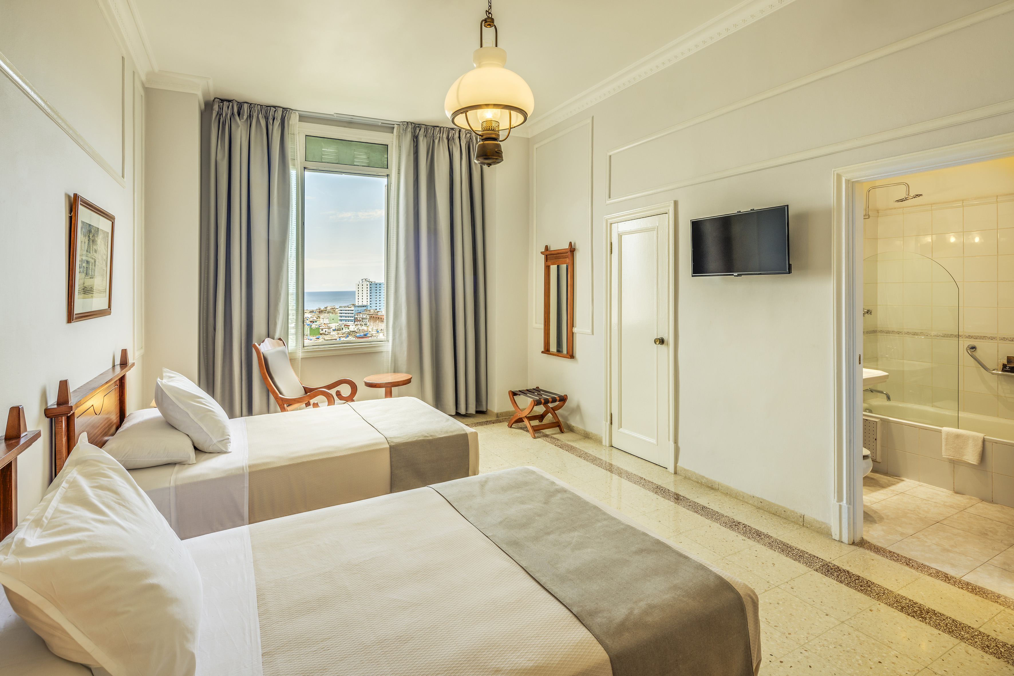 a room with two beds and a television