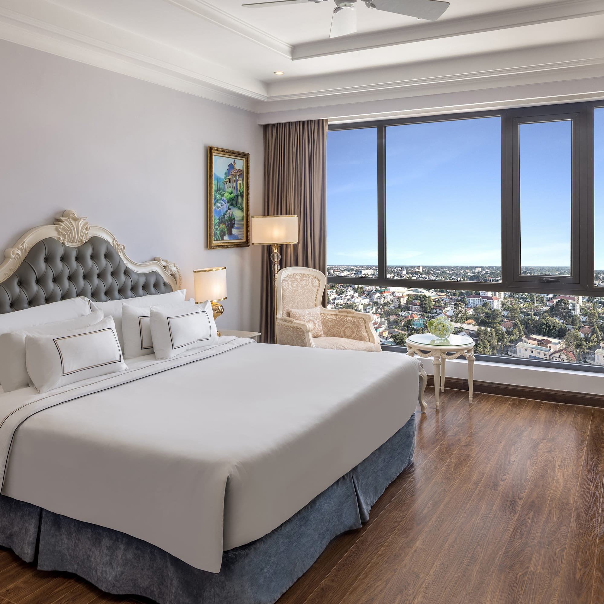 a bedroom with a large window and a large bed