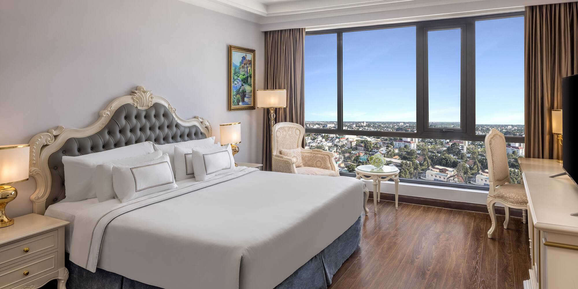 a bedroom with a large window and a large bed