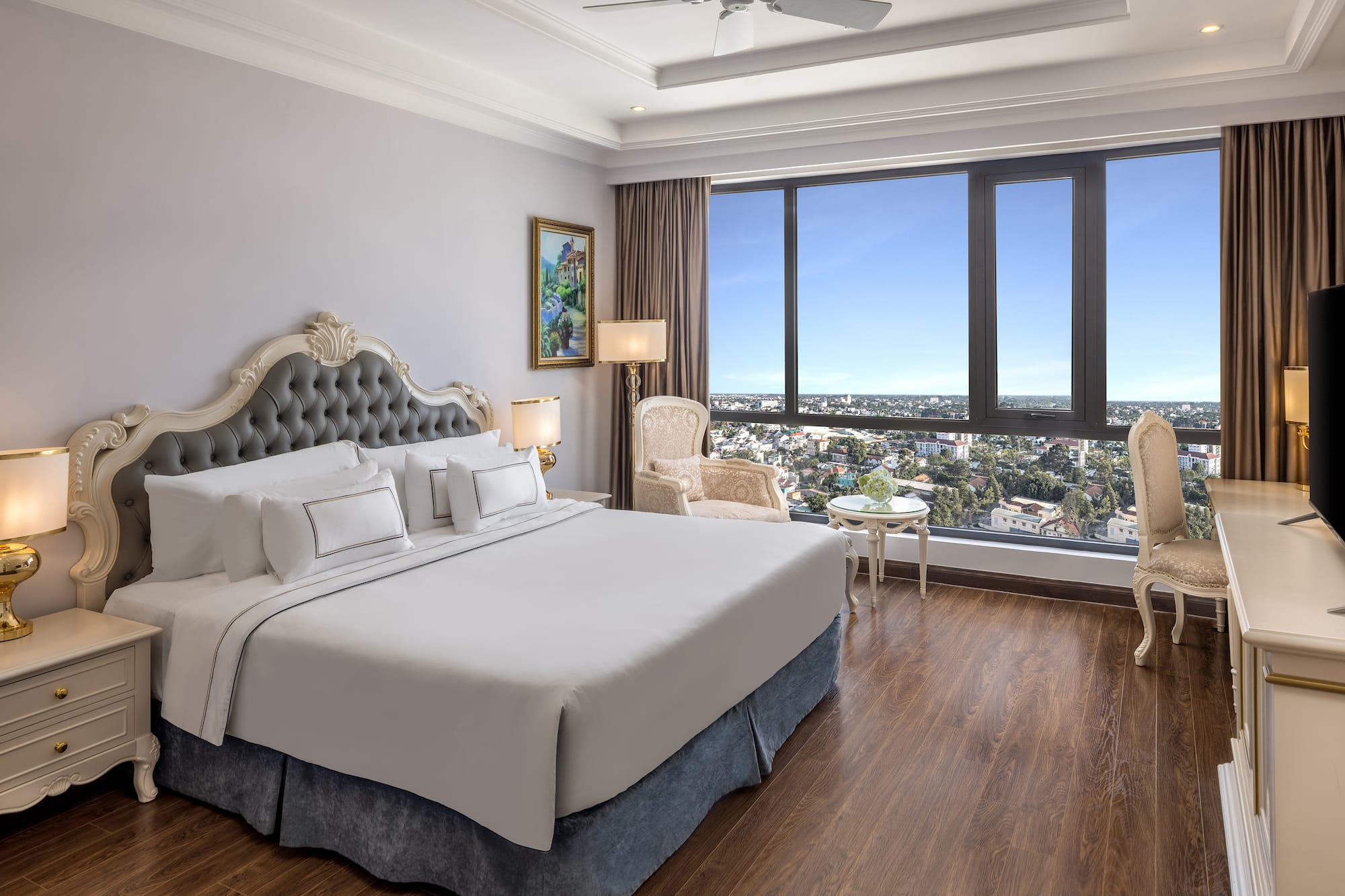 a bedroom with a large window and a large bed