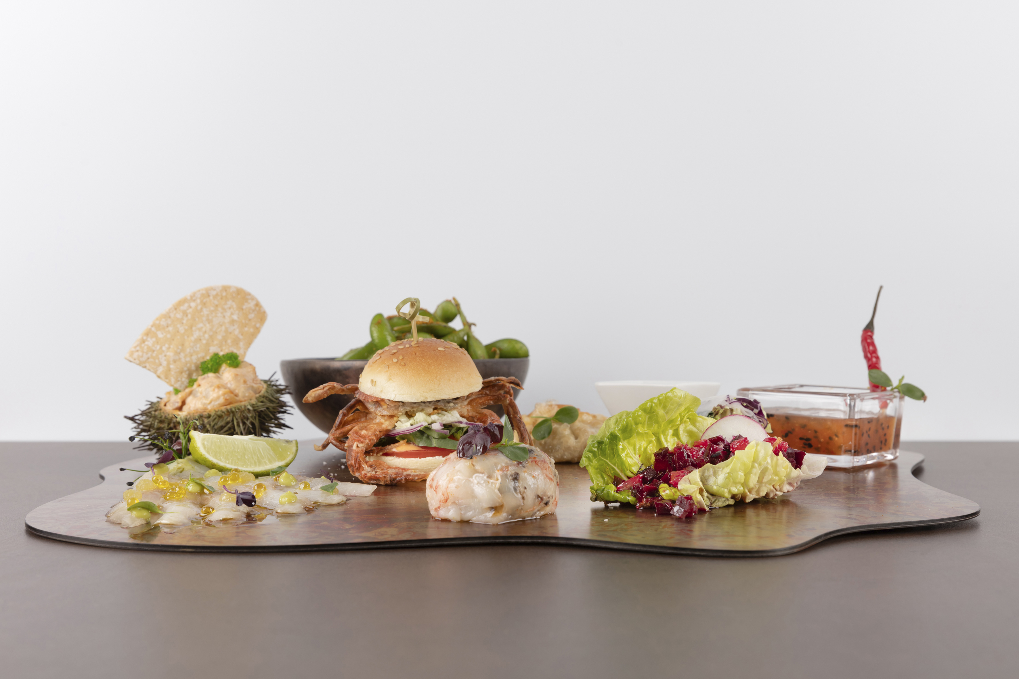 Seafood appetizers: soft shell crab, sea urchin, fish carpaccio, edamame.