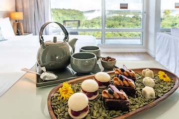 a tray of desserts and tea cups