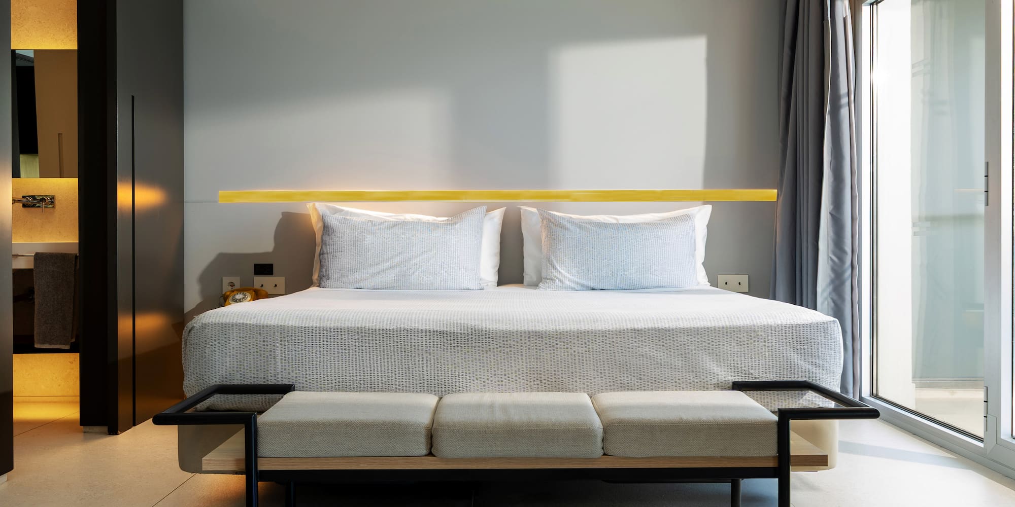 a bed with a bench in a room