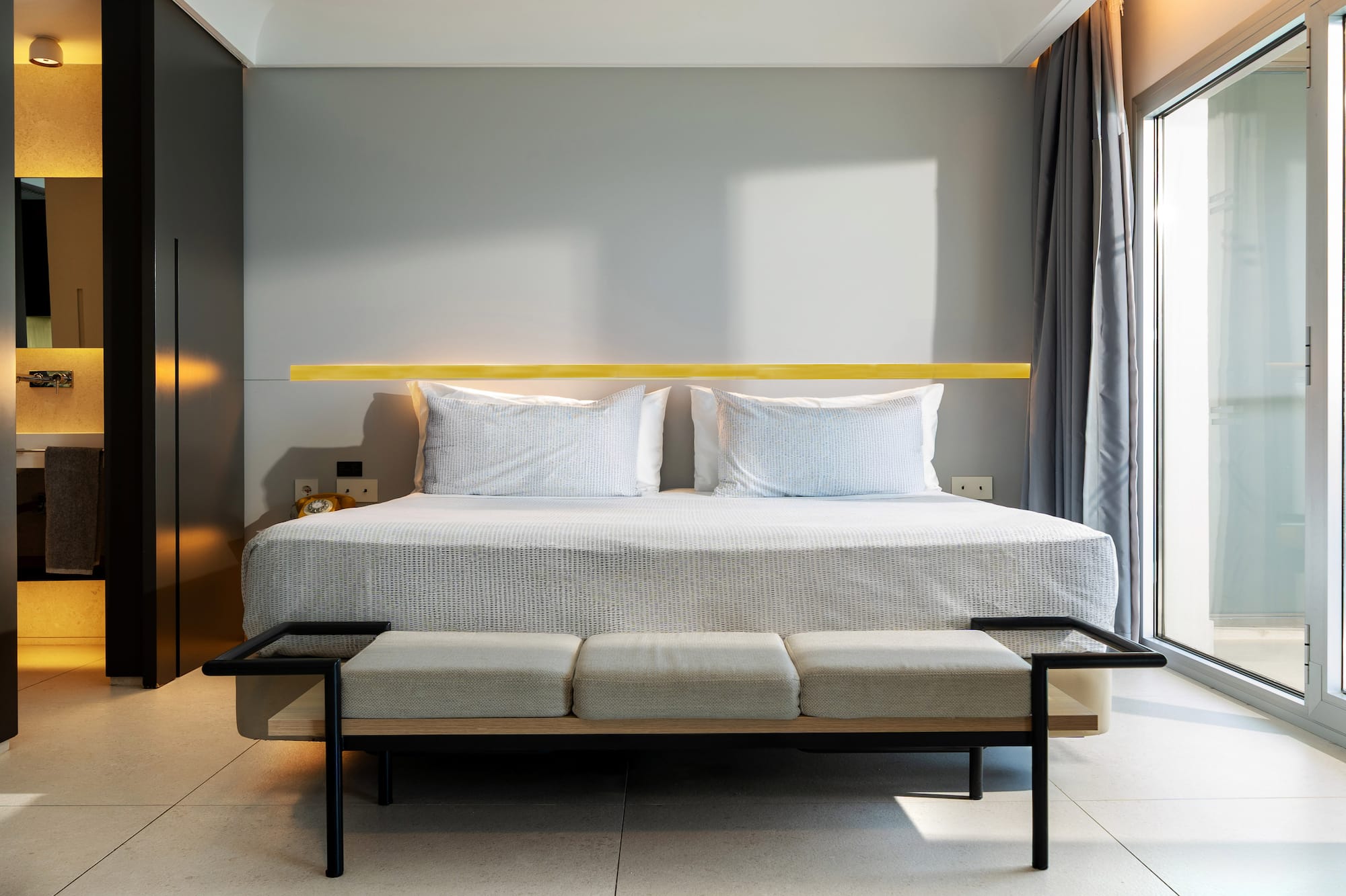 a bed with a bench in a room