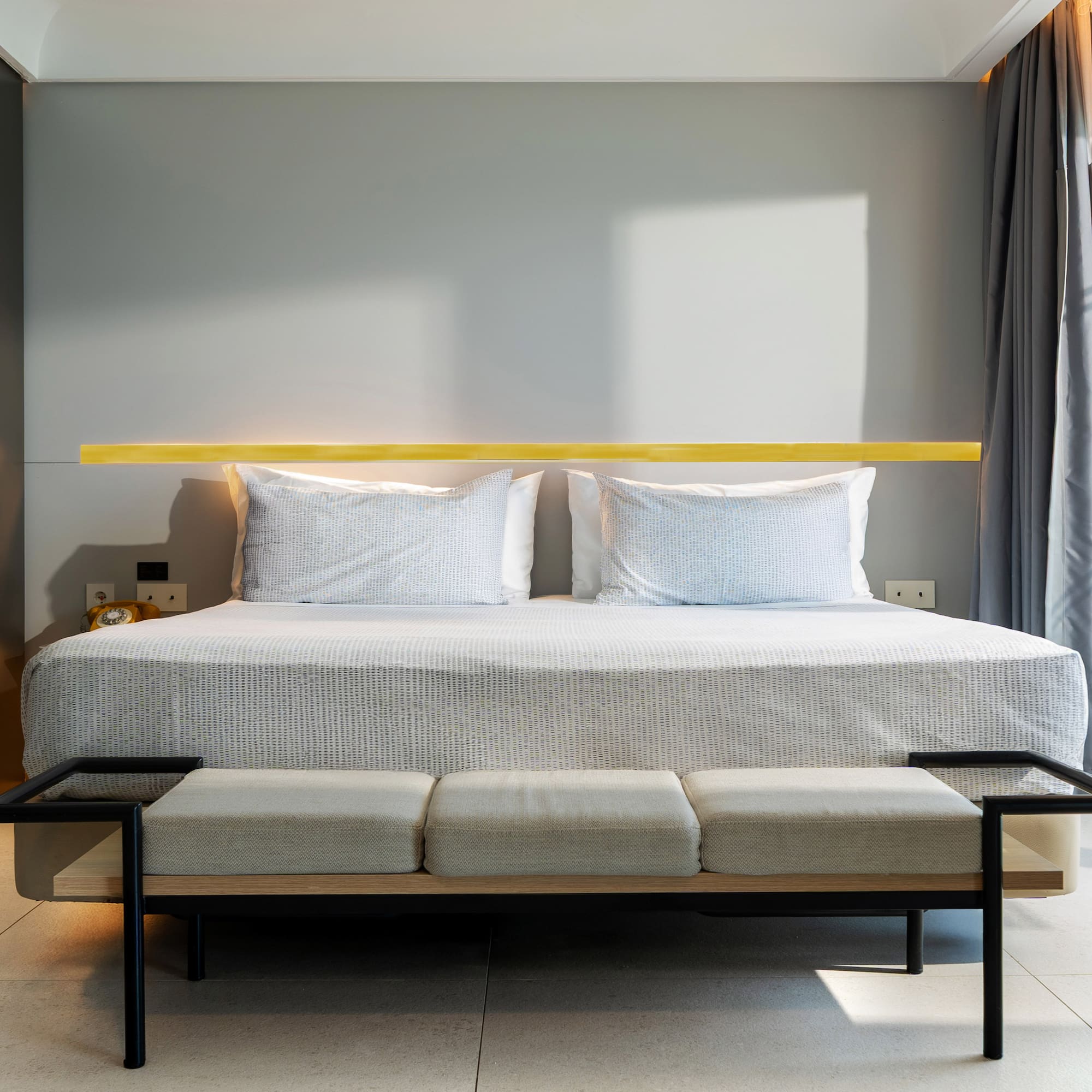 a bed with a bench in a room